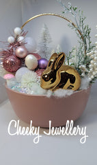 Cute as a button easter winter garden, with bronze bunny with pink and snowy setting.