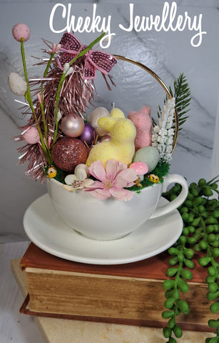 Cute as a button easter spring garden, with fuzzy foam bunnies with pink and spring tea cup setting