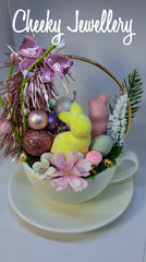 Cute as a button easter spring garden, with fuzzy foam bunnies with pink and spring tea cup setting